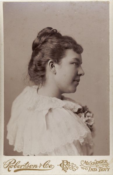 Quarter-length studio portrait of Miss Emma Coleman, a Cherokee Indian. She is facing right in a semi-profile.