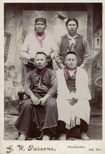 Four Osage men pose for a portrait.