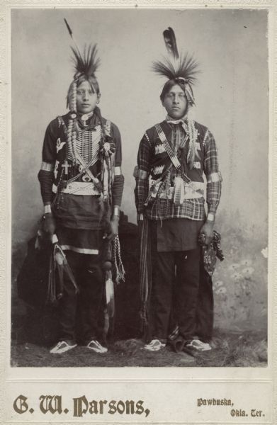 Two Osage men in native dress.