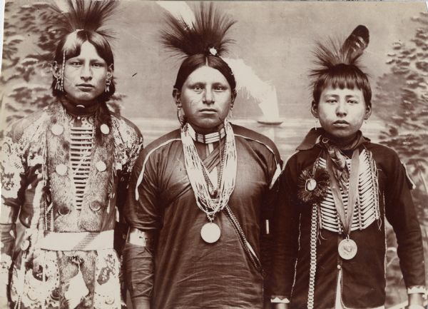Three Osage men in full dress.  This image comes from an Osage album with the inscription: "Compliments of G.W. Parsons."