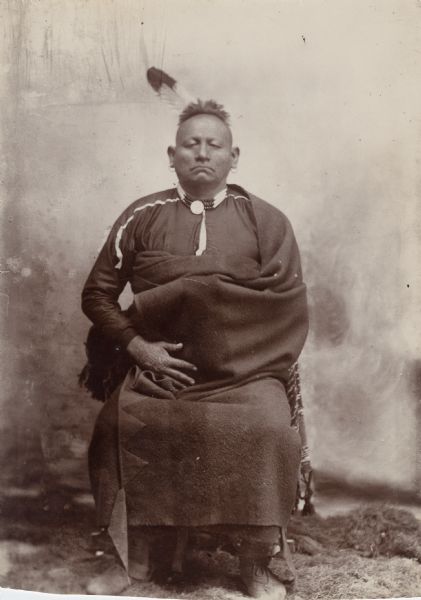 Studio portrait of an Osage man, possibly second chief Olohawalla. This image comes from an Osage album with the inscription: "Compliments of G.W. Parsons."