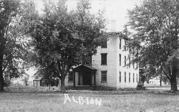 Men's dormitory at Albion Academy. Caption reads: "Albion".