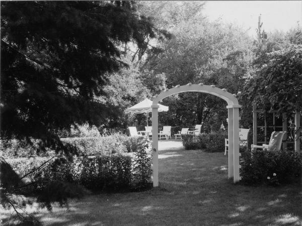 A rose garden with a trellis on the estate of Albert C. Neufeld at 204 West Whitney.