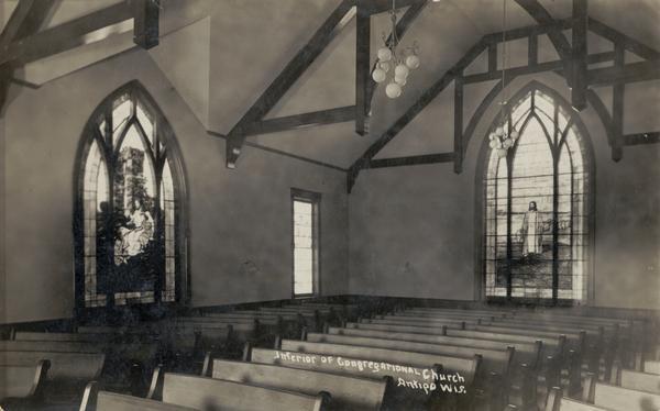 Interior view of Congregational Church with stained glass windows.