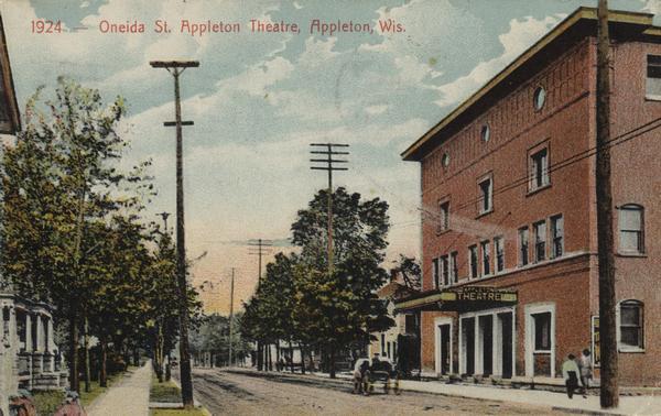 View down sidewalk on the left with the theatre across the street on the right. Caption reads: "Oneida St. Appleton Theatre, Appleton, Wis."