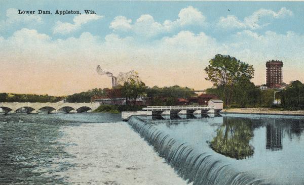 View across dam on the Fox River, with a bridge further down on the left, and a tall building on the right. Caption reads: "Lower Dam, Appleton, Wis."