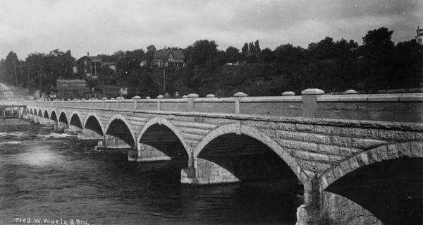 View of the John Street Bridge on the right crossing over the Fox River.