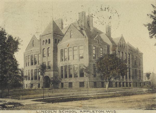 View across street toward the school. Caption reads: "Lincoln School, Appleton, Wis."