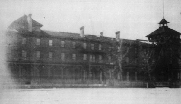 View of the original Hotel Chequamegon, built by the Wisconsin Central Railroad interests and opened in 1877. It was built of wood with a wrap around porch on first level and a second level balcony. It faced the bay and had a long series of steps leading to a boat landing. The hotel was condemned as a fire trap and razed in the 1890's.