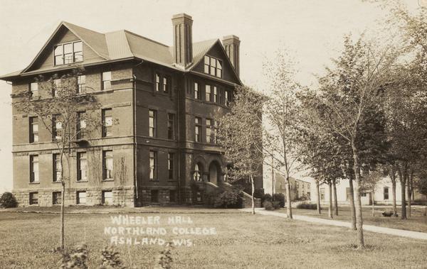 Wheeler Hall at Northland College, a three story building with basement and attic. Built in 1893 of red brick and brownstone in the Romanesque Revival style. It is surrounded by a lawn, trees and other buildings. An extensive Property Record is on the Wisconsin Historical Society website, see "Property Record, 1411 Ellis Ave, Architecture and History Inventory." It is listed on the State and National Register of Historic Places.