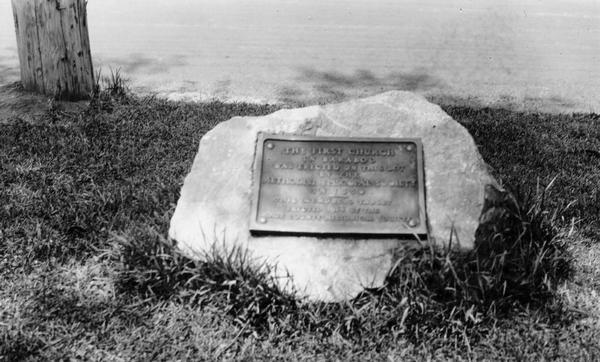 Historic site marker to commemorate the first church in Baraboo.  The inscription reads "The first church in Baraboo was erected on this lot by the Methodist Episcopal Society in 1850.  This memorial tablet erected 1914 by the Sauk County Historical Society."