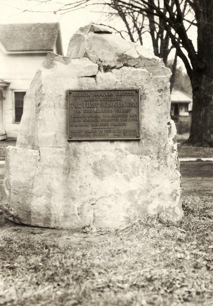 A marker on a rock commemorates the first schoolhouse built in Baraboo.