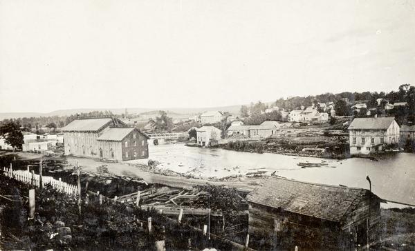 View of the Baraboo River and surrounding structures.