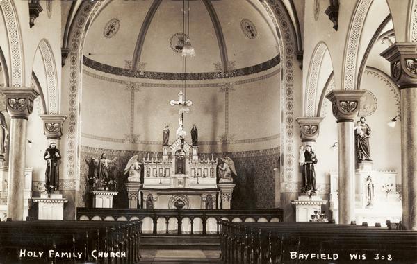 Interior view of the Holy Family Church. Caption reads: "Holy Family Church, Bayfield, Wis."