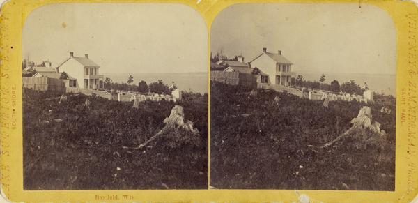 Stereograph of buildings on a hillside.
