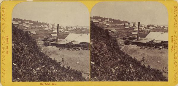 Stereograph view of Bayfield with a sawmill in the foreground.