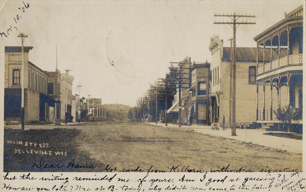 View down unpaved street. Caption reads: "Main Street, Belleville, Wis".