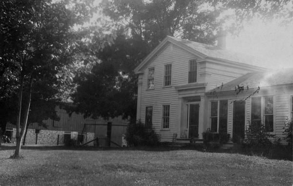 View of what possibly was the Morehead residence, in the vicinity of Belleville. The home was built in 1858, designed and built by William Close, carpenter of Verona, Wisconsin. There are three houses in the vicinity, all designed alike and built by Close. This one is situated 2.5 miles north of the town on the bank of Sugar River. At the time of this photograph, three generations of Moreheads have lived here: William, his son (also William), and his grandson, Orlo C. Morehead.