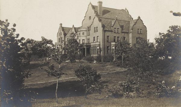 View of Emerson Hall, with trees and a lawn in the foreground.