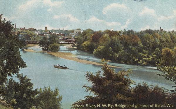 Elevated view of the Rock River. Caption reads: "Rock River, N.W. Ry. Bridge, and glimpse of Beloit, Wis."