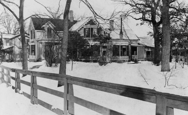 View of the William Porter house. A fence is in the foreground. It was built and designed by Lucas Bradley in the cottage Gothic style in 1855.