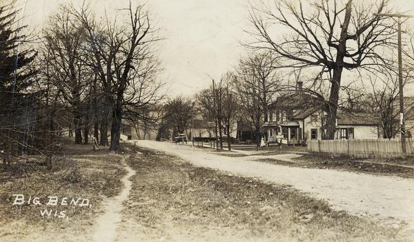 View of a road and houses. Caption reads: "Big Bend, Wis."