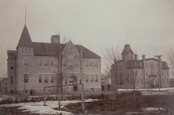 View of the high school, (left) and grade school. The older building on the right originally held both high school and elementary school classes, but was converted to purely elementary classes after 1897 when the other building was constructed.