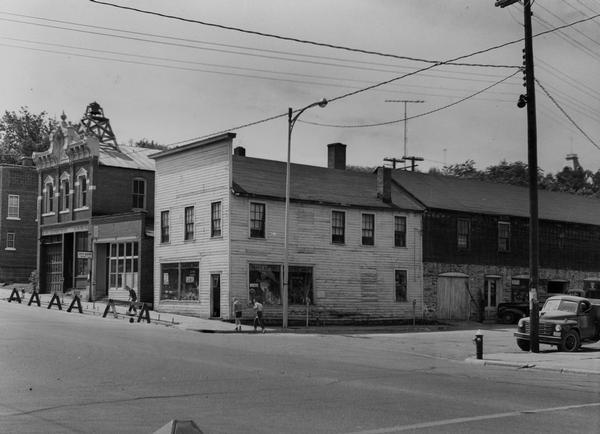 View of Main Street, lined with the fire department, city clerk's office, and Pugh's Battery - Electric Shop.