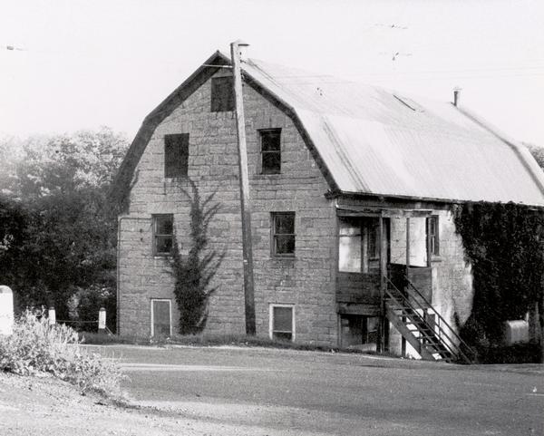The stone building formerly housed the flour mill. The mill was established in 1852, but had pretty well gone out of business by 1895, by which time the pond which supplied it with water had silted up.