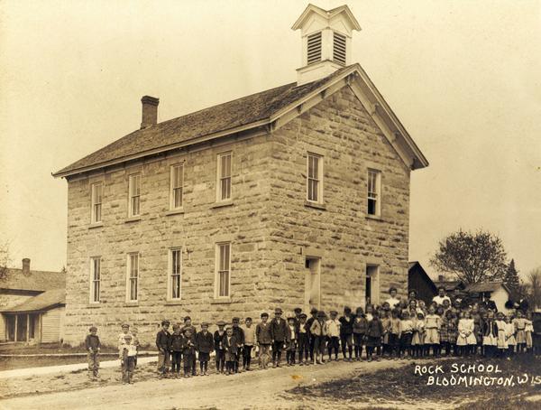 The "Rock School" building, with children and teachers posed outside.