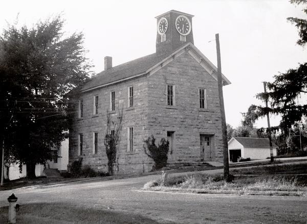 School known as the "old stone school," the first public school building in Bloomington. The clock tower replaced the former bell tower.