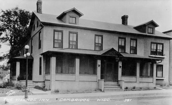 Front view of the Village Inn. Caption reads: "The Village Inn Cambridge Wisc."
