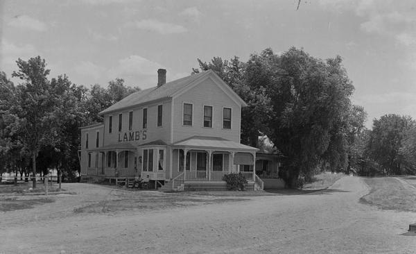 Lamb's Hotel on a dirt road. The hotel is also called Bewersdorf's Hotel.