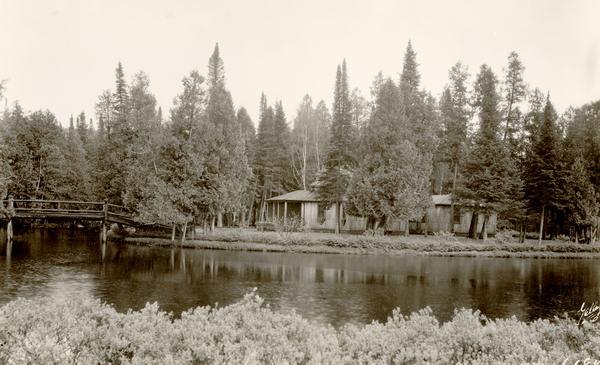 Cedar Island on Brule River, a nationally known speckle trout stream. The island has native towering white pine and bubbling clear springs. These are some of the buildings on the Pierce Estate which were occupied by President Coolidge and his party in June, 1928. This is about 30 miles from Superior.