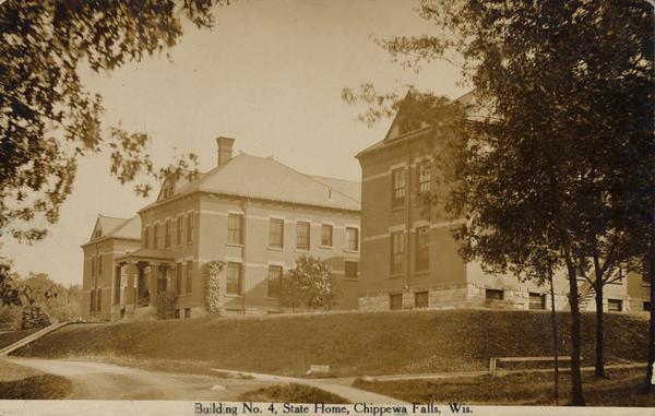 Building No. 4, then known as the Wisconsin House for the Feeble-Minded. Caption reads: "Building No. 4, State Home, Chippewa Falls, Wis."