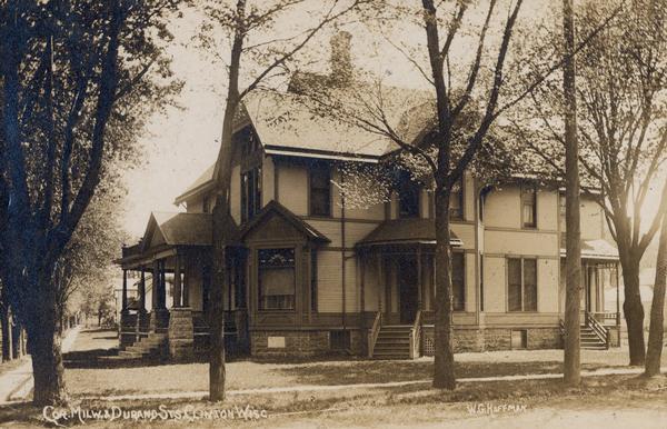 House on the corner of Milwaukee and Durand Streets. Caption reads: "Cor. Milw. & Durand Sts, Clinton, Wisc."
