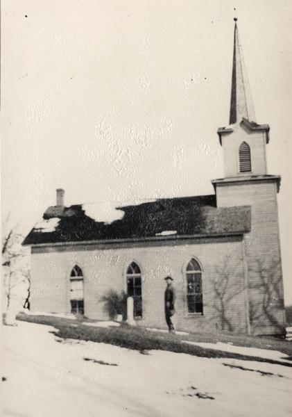 Exterior of church, with snow on the ground.