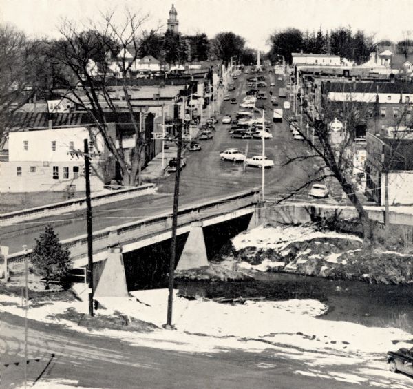 Elevated view of street with bridge in Darlington. Cars are parked in the center of the street at an angle.