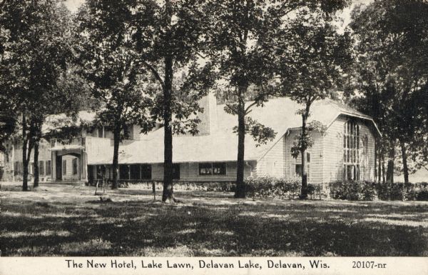 View of the hotel across the grounds and through trees. Caption reads: "The New Hotel, Lake Lawn, Delavan Lake, Delavan, Wis."