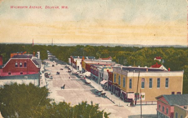 Elevated view of a broad downtown street. Caption reads: "Walworth Avenue, Delavan, Wis."