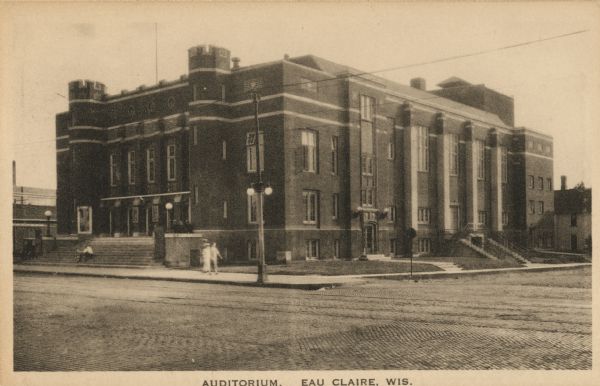 View from intersection of the Auditorium on a street corner. Caption reads: "Auditorium. Eau Claire, Wis."