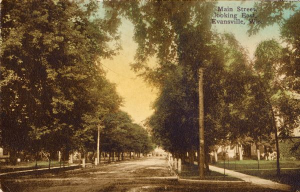 View down tree-lined Main Street. Caption reads: "Main Street, looking East, Evansville, Wis."