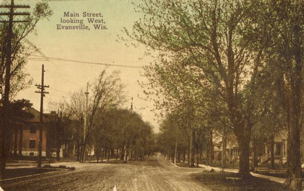 View down unpaved Main Street. Caption reads: "Main Street, looking West, Evansville, Wis."