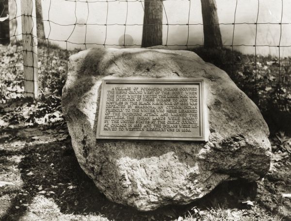 Close-up view of the Big Foot village marker erected by the Geneva Lake Historical Society. The plaque reads: "A village of Potawatomi Indians occupied the rising ground west of this point when the first whites visited the lake, May 1831. The intention of these Indians to join the hostiles in the Black Hawk War of 1832 was defeated by Shabbona, an Ottawa Indian friendly to the whites, who here learned of the impending attack and warned the settlers. The Indian lands were bought by the United States at the Great Council at Chicago in 1833 and the Indians were removed to western reservations in 1836."