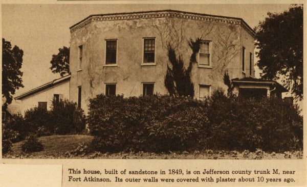 View of the octagon house. The caption below the photograph reads: "This house, built in 1849, is on Jefferson county trunk M, near Fort Atkinson. Its outer walls were covered with plaster about ten years ago."