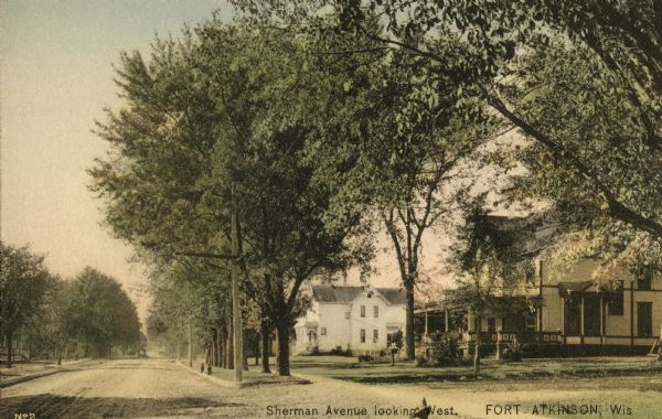 View down Sherman Avenue looking west. Houses and trees are on the right. Caption reads: "Sherman Avenue, looking West. Ft. Atkinson, Wis."
