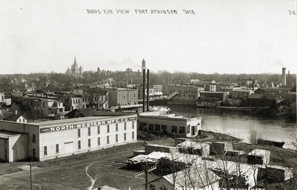 Elevated view of Fort Atkinson, including the North Western Manufacturing Company plant along the river. Caption reads: "Birds Eye View, Ft. Atkinson, Wis."