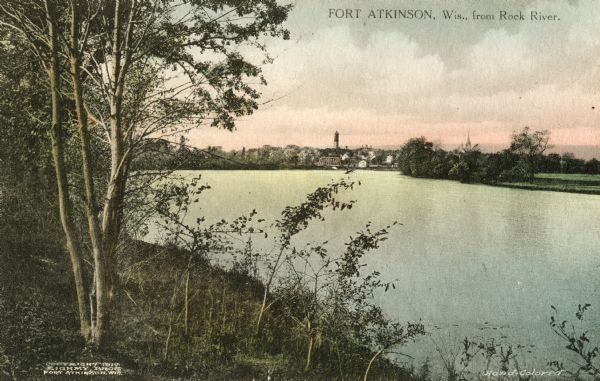Distant view of Fort Atkinson from the shoreline of the Rock River. Caption reads: "Fort Atkinson, Wis., from Rock River."