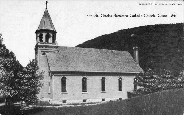 Right side view of the church. A hill is behind the church on the right. Caption reads: "St. Charles Borromeo Catholic Church, Genoa, Wis."