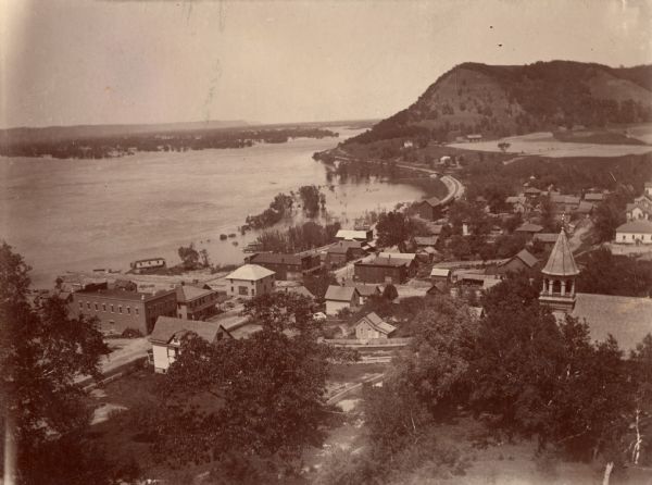 Elevated view of Genoa along the Mississippi River. Scene of the last battle between the United States forces and the Native Americans under Chief Black Hawk on August 21, 1832. The steamer Warrior, Captain Joseph Throckmorton, with soldiers and artillery from Fort Crawford, Prairie du Chien, took an active and important part in this battle.